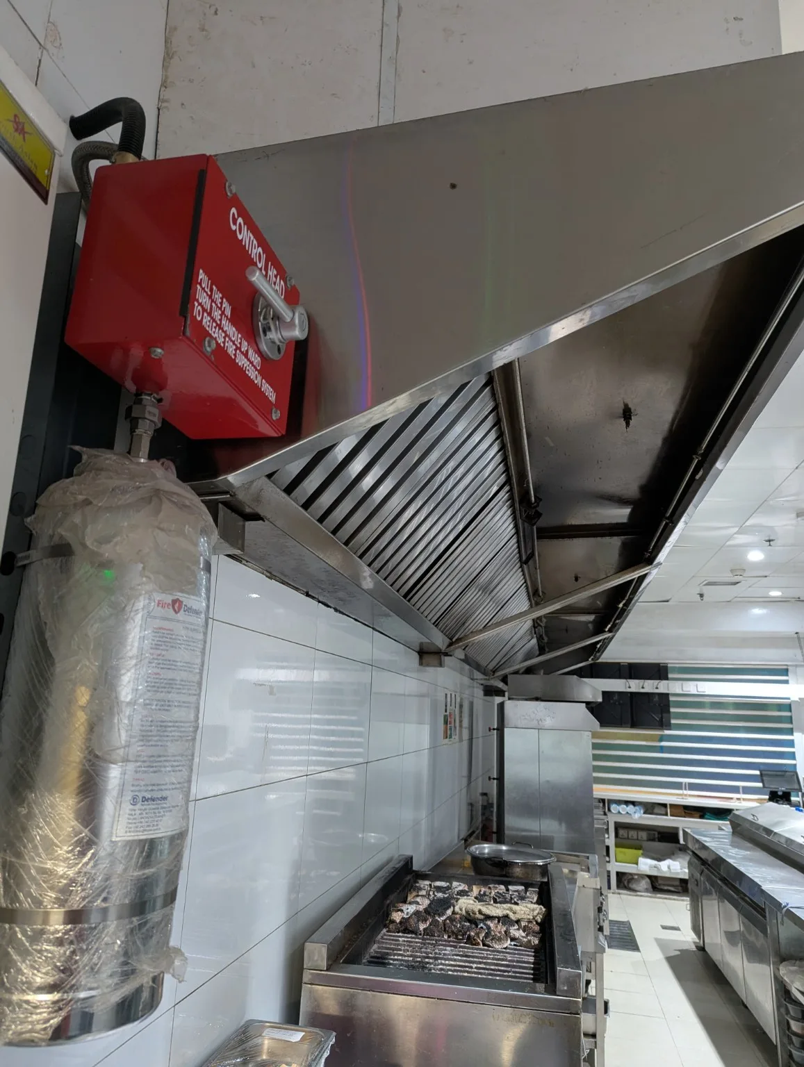 Protected commercial kitchen cooking line